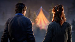 Two people look out into the distance, where a circus tent glows in the darkness
